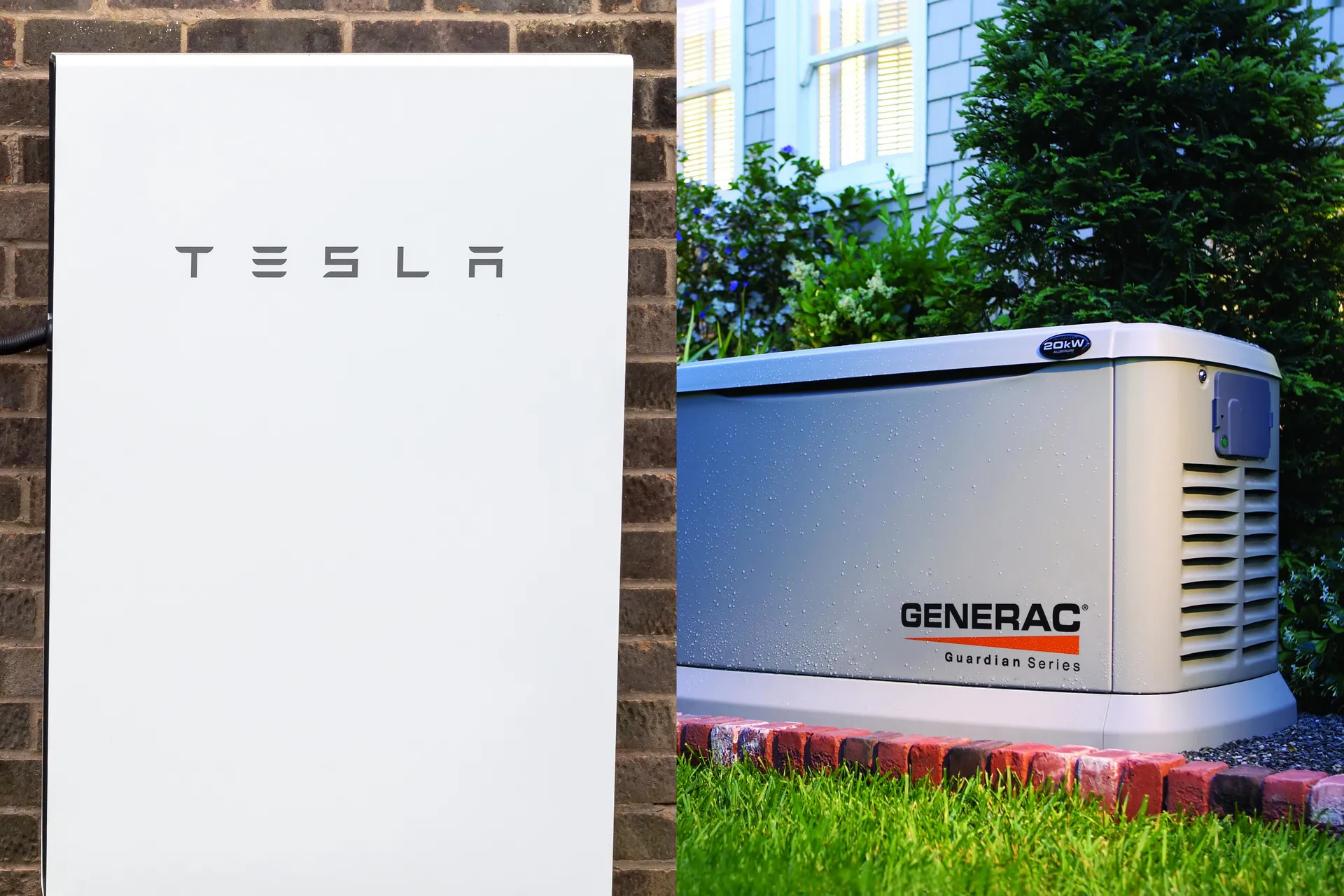Side-by-side image of a Tesla Powerwall on a brick wall and a Generac Guardian Series generator on a lawn near a house.